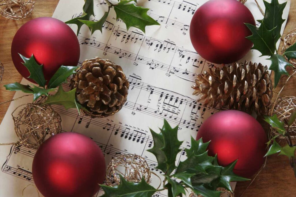 Christmas Eve: A Night of Traditions and Magic 4 christmas scene with holly ilex red baubles fir cones and sheet music 121808841 59c28363d088c00011273ee8