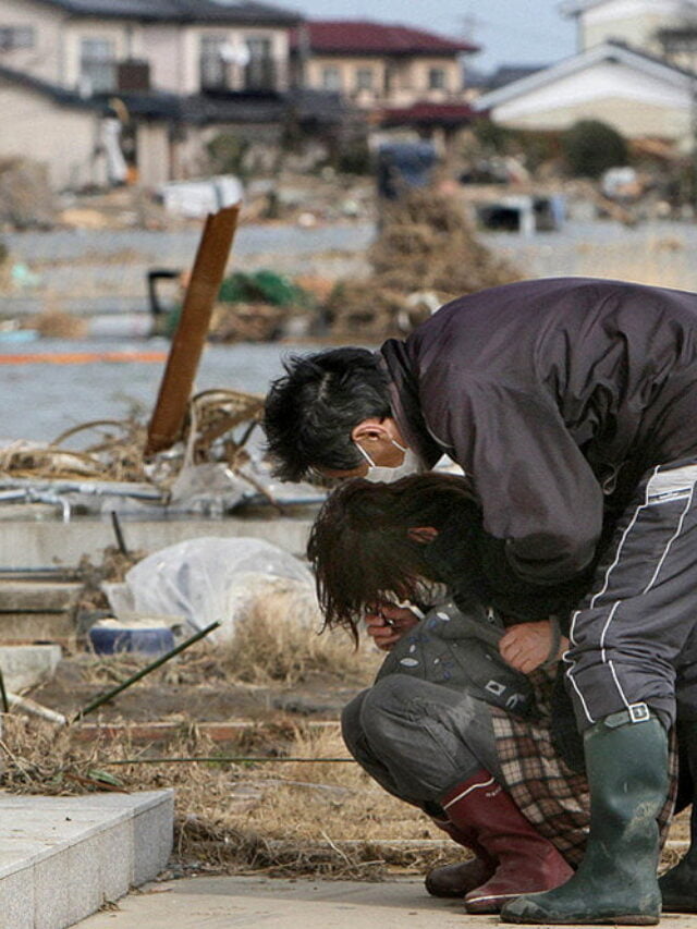 A man comforts a woman as she cries in f